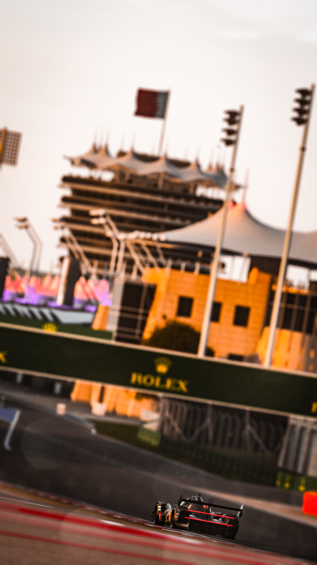 Hypercar on the Bahrain pit straight at sunset